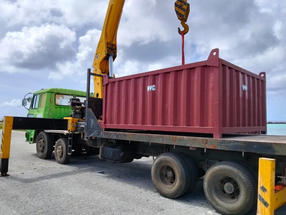 HYC boom truck lifting an HYC cargo container