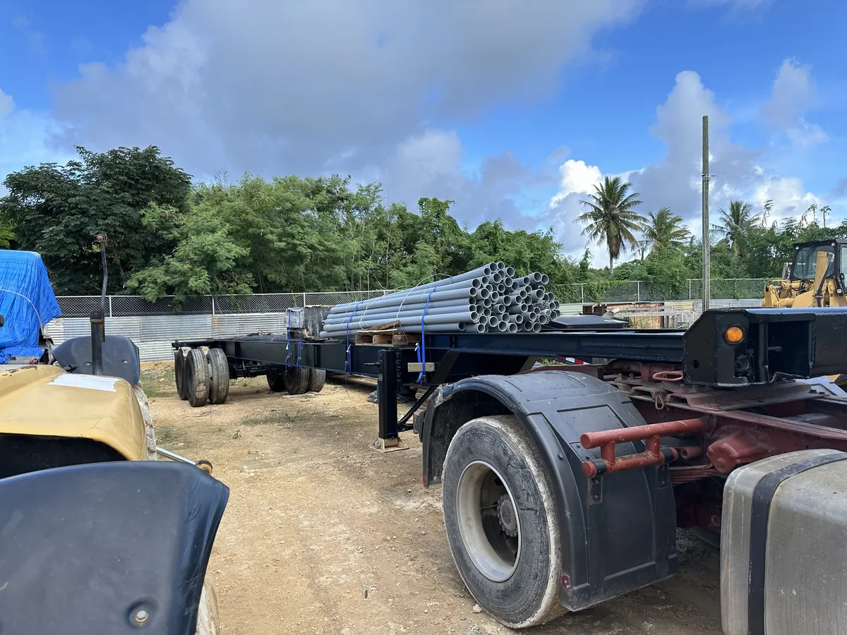 Lowboy trailer loaded with steel pipe