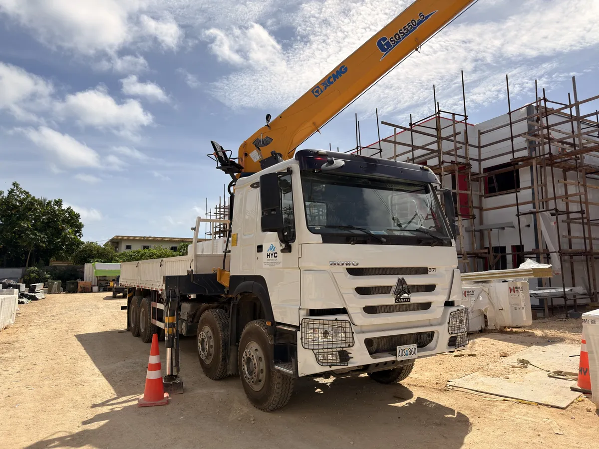 HYC boom truck working beside a building under construction