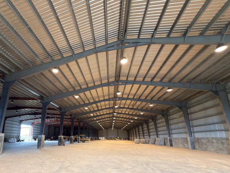 High-bay steel clear-span structure inside HYC's Tinian warehouse used for equipment laydown and cargo staging