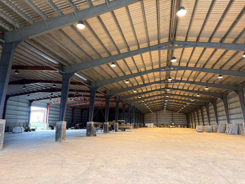 Interior of HYC's Tinian warehouse rental space with high-bay clear-span storage and concrete flooring